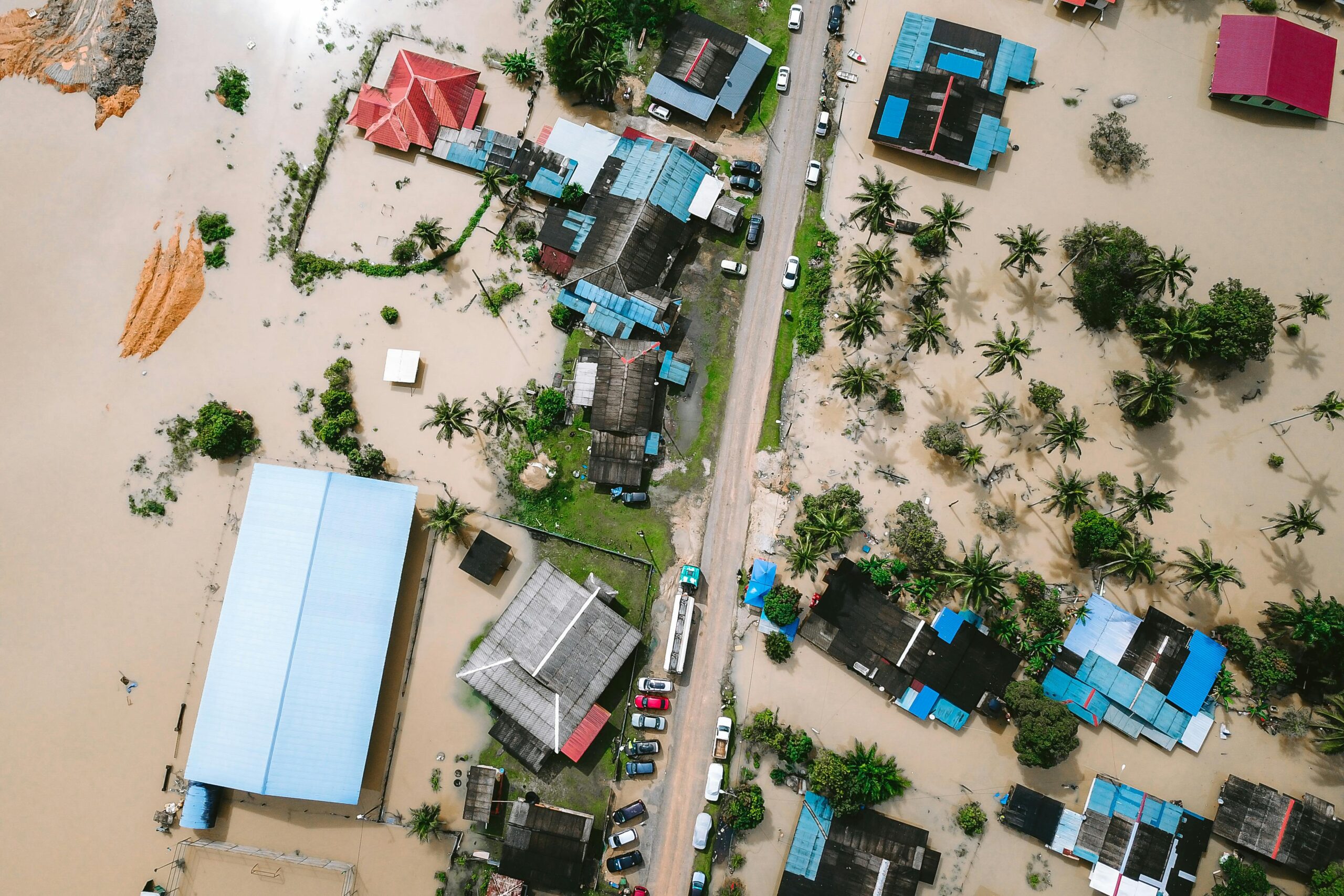 Drone view of a residential area in Kijal, Malaysia, showing extensive flooding and submerged buildings.